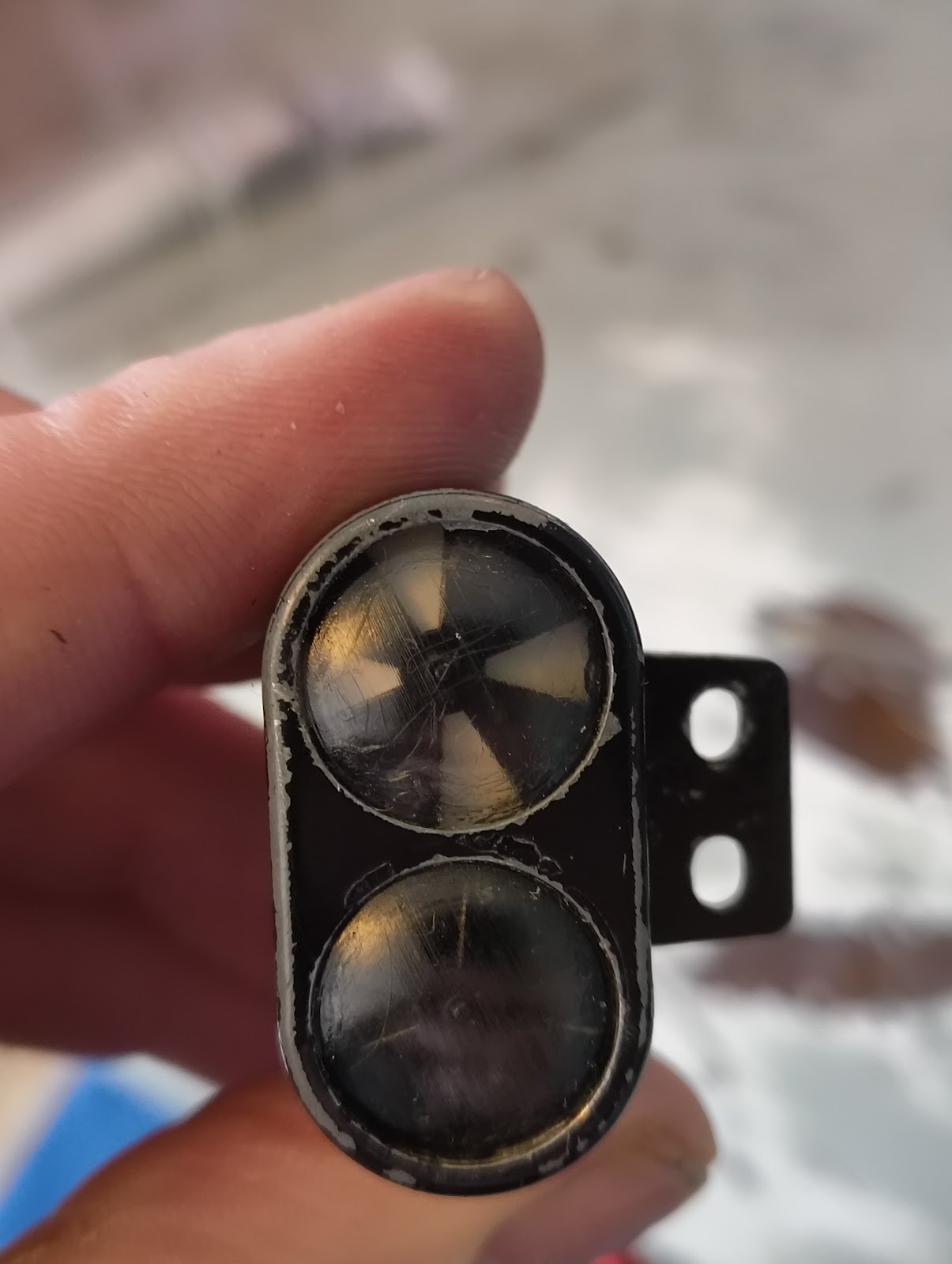 The indicators are really beautiful and mechanical. No lights! The white cross is normally hidden under the black but when powered on, turns and becomes visible. When powered off, it is pushed back by a little spring. Unfortunately they don't work so let's fix them.Taken apart and glued back. Time to re-install it. Here I didn't put the springs back yet, so the white is visible.